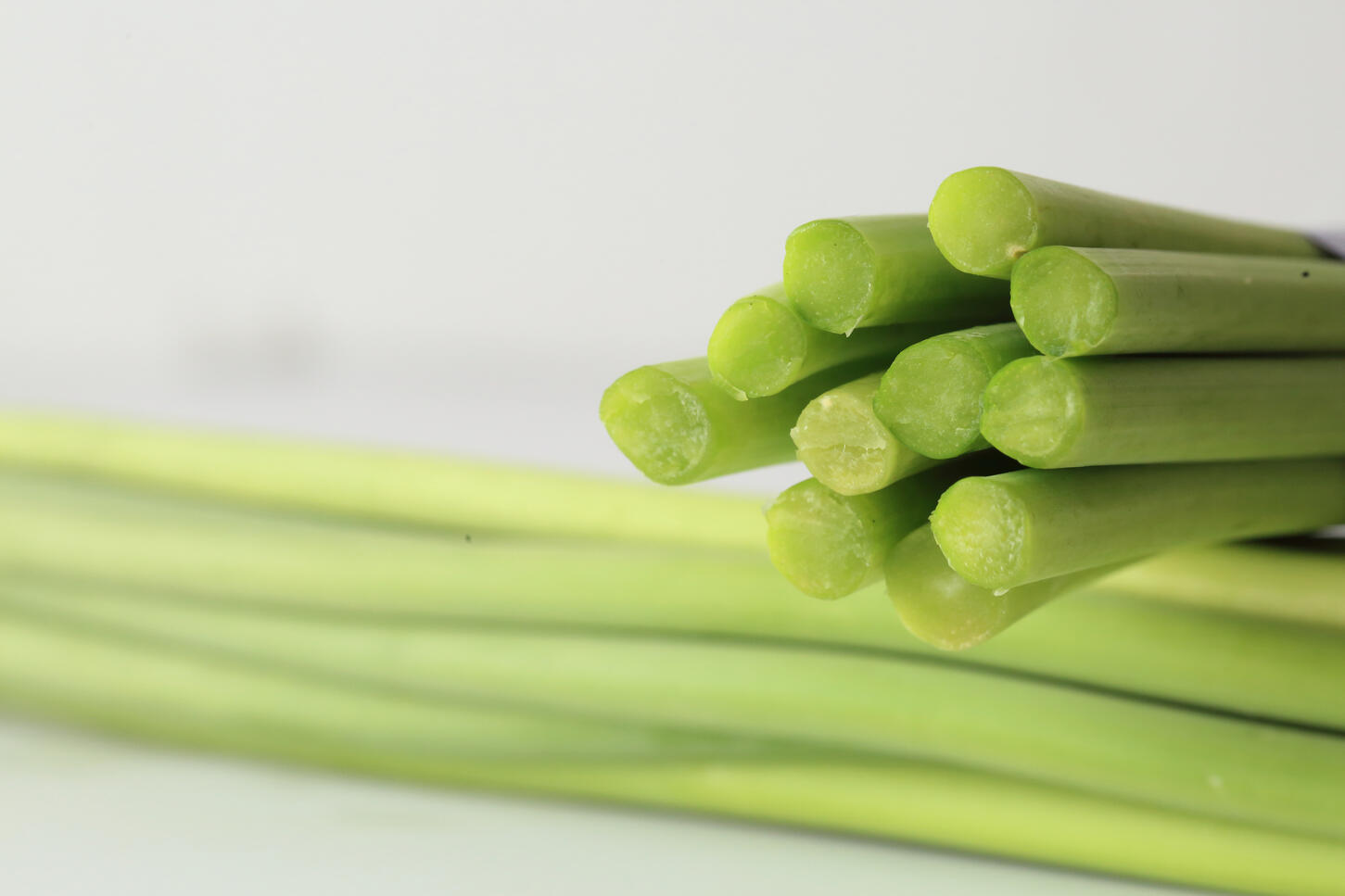 Close-up of freshly cut green vegetable stems showing texture and moisture