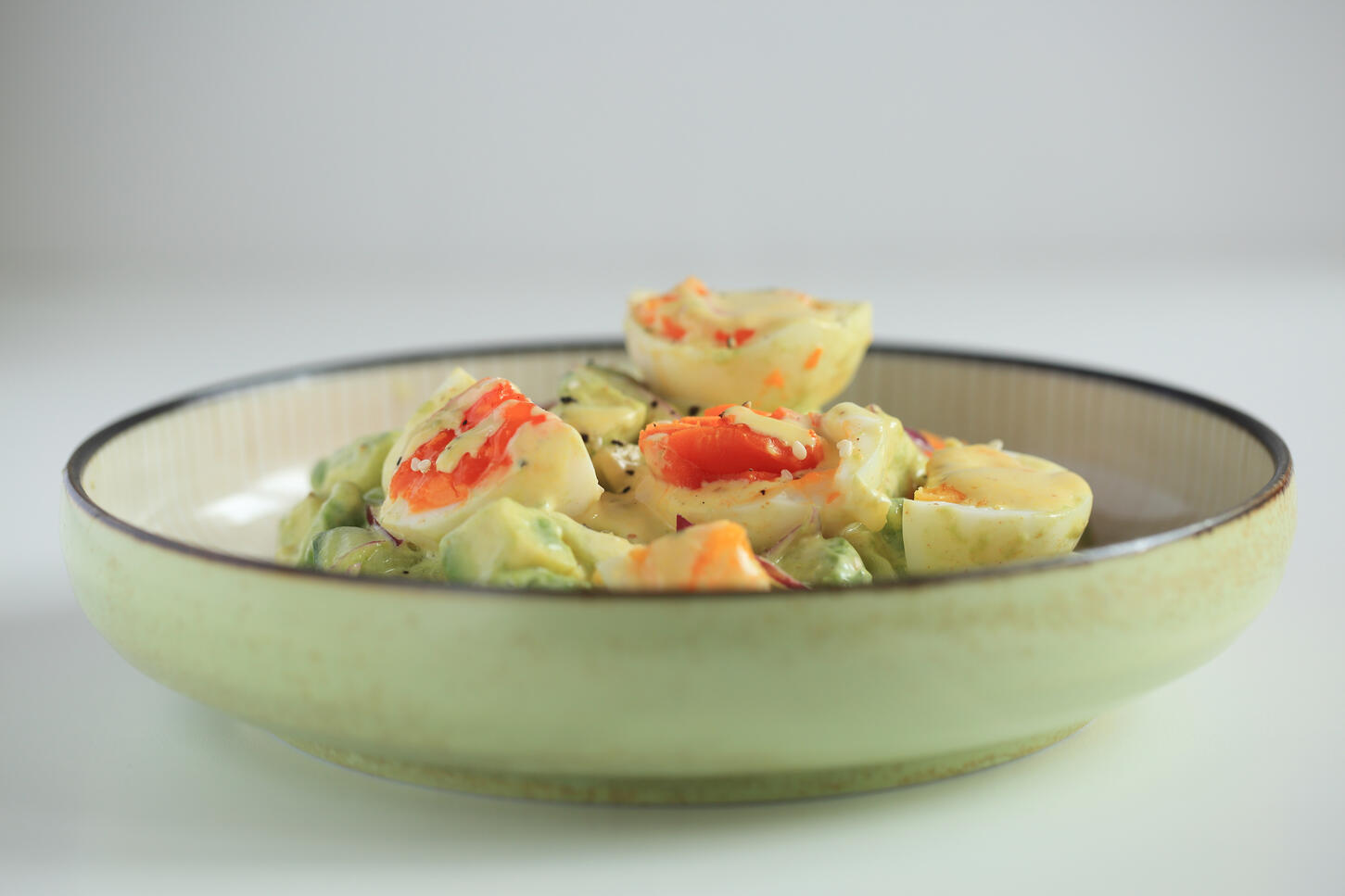 Japanese-style egg salad with vegetables plated in natural light food photography