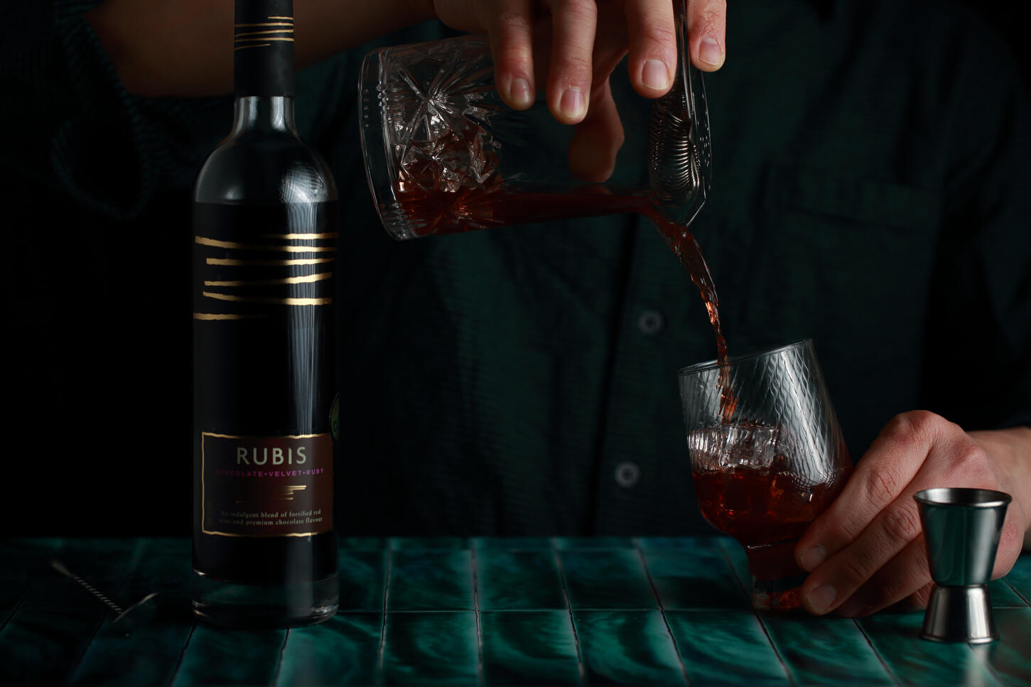 Finishing a Rubis wine cocktail in dark atmosphere lighting