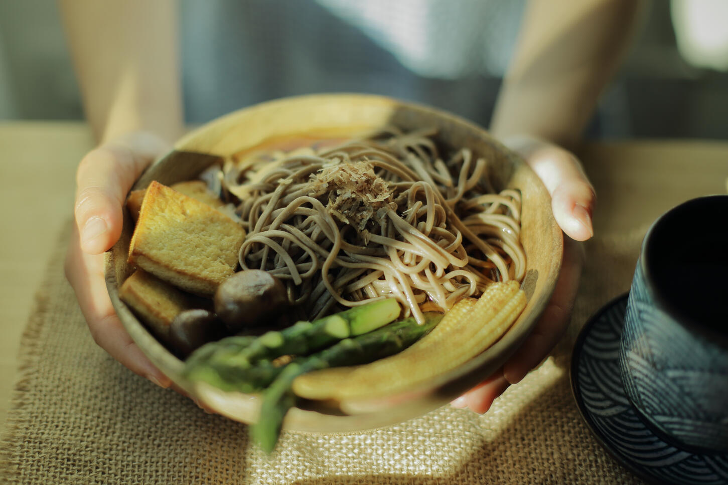 Flat lay of cake being sliced on marble surface in natural light food photography