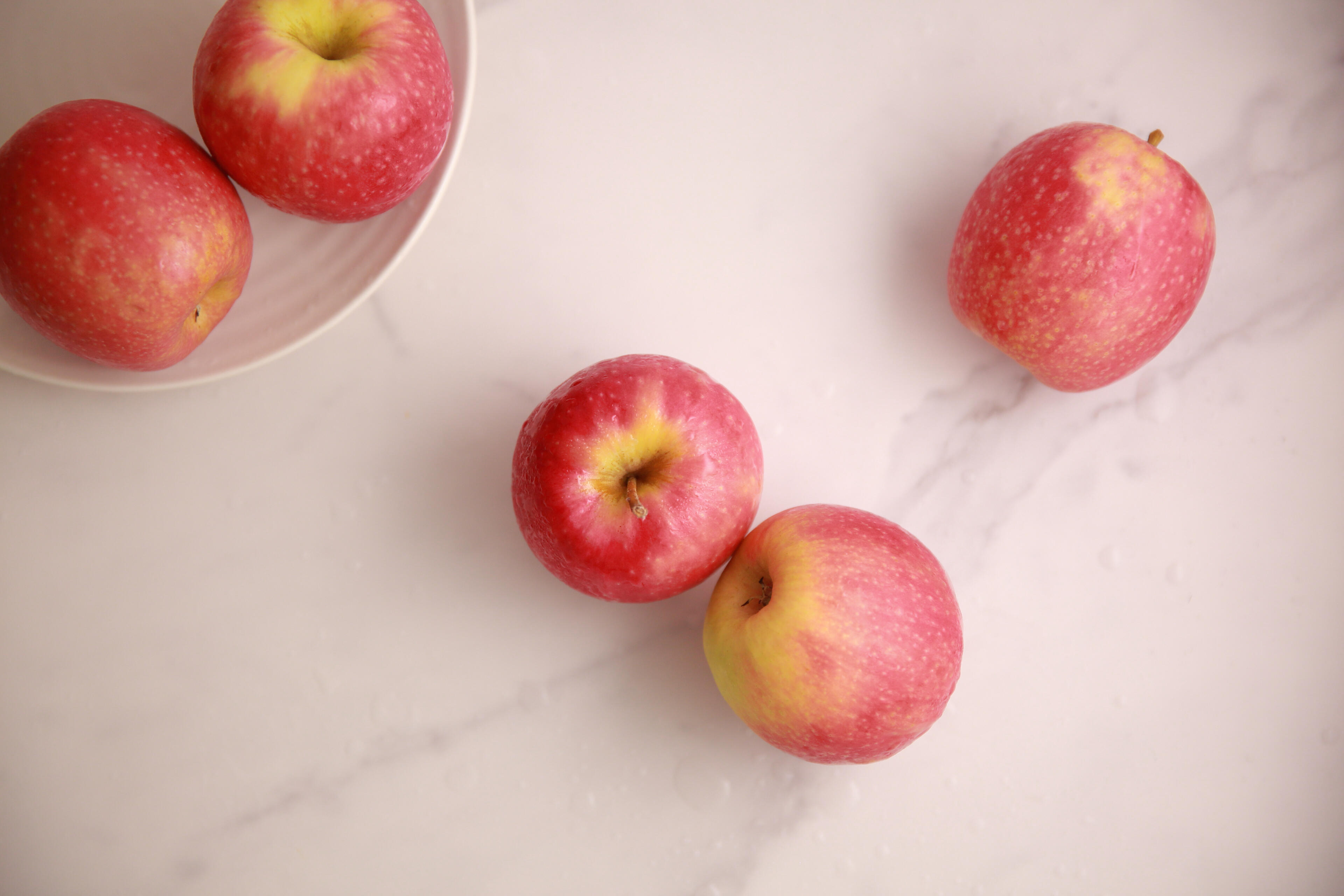 Simple apples Fresh apples arranged on marble surface in natural light