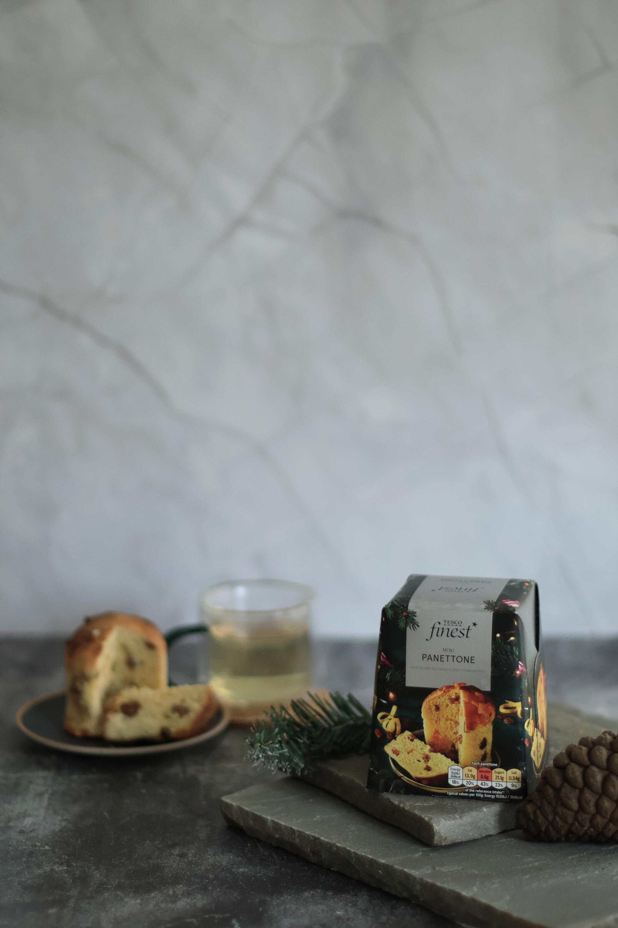 Tesco mini panettone styled on grey stone surface with moody side lighting for food photography in Horsham serving London and the South East
