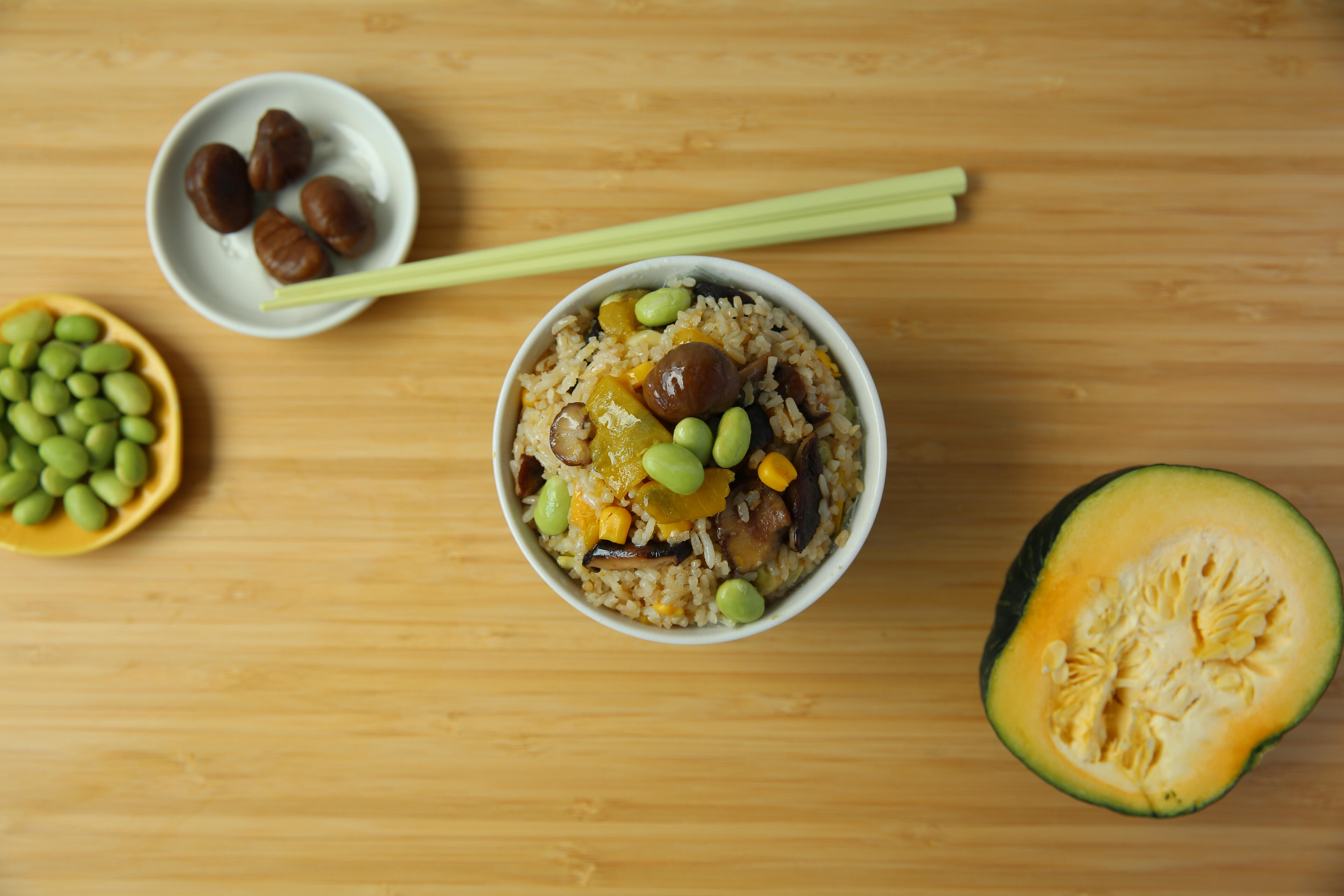 Seasonal Japanese rice dish Flat lay of Japanese rice with pumpkin and chestnut styled in Japandi aesthetic