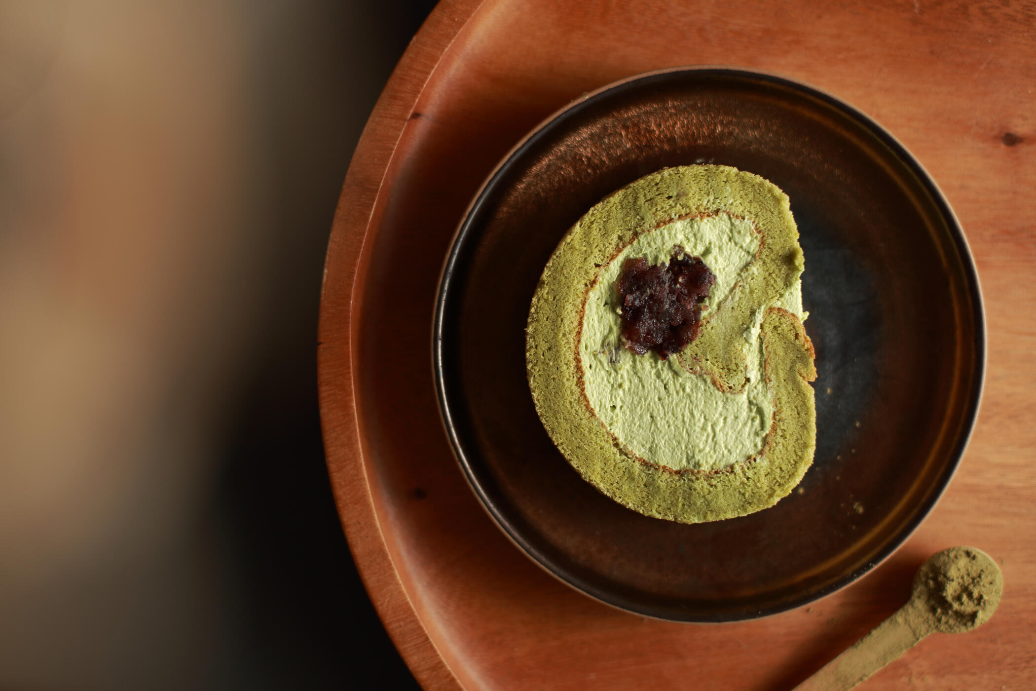 Japandi matcha Swiss roll Japandi style matcha red bean Swiss roll photographed in minimal flat lay composition for food photography in Horsham serving London and the South East